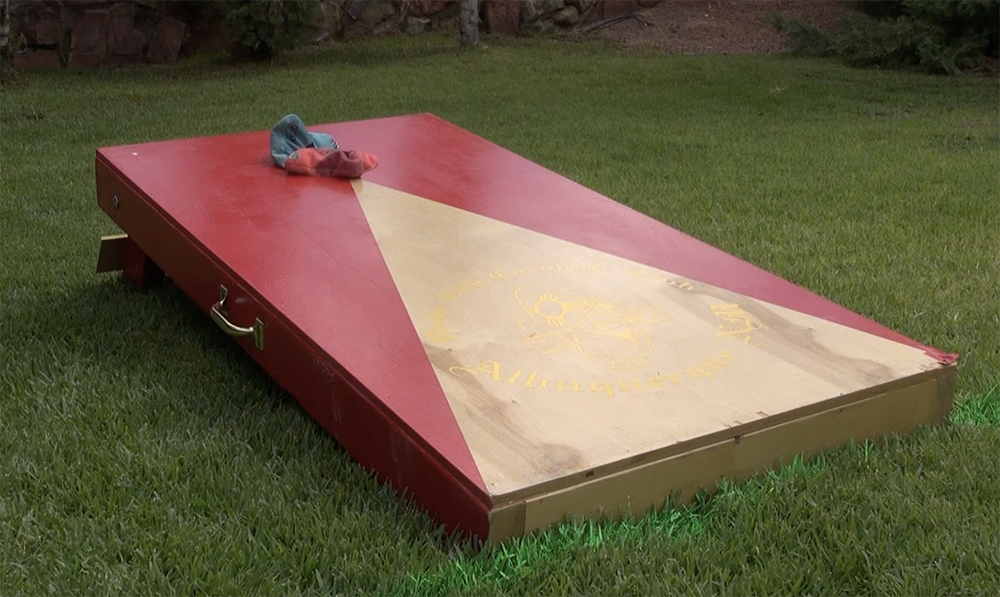 cornhole board on grass